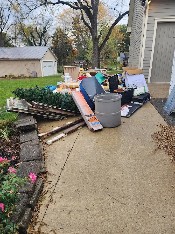 Dumpster being loaded with debris for Estate Cleanout Dumpster Rental in East Basin